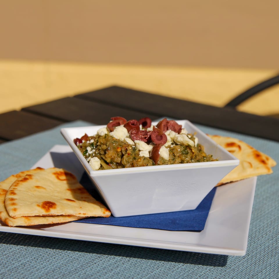 Spiro's Taverna's Greek eggplant dip with feta and olives, served with pita bread.