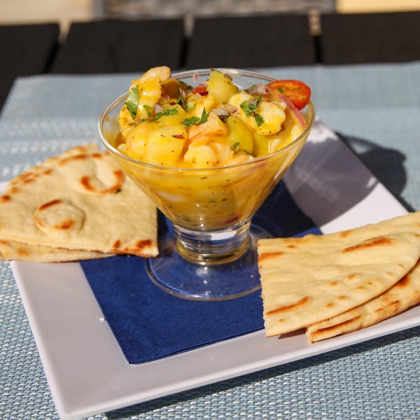 Spiro's Taverna's shrimp ceviche with pineapple and tomatoes, served with pita bread.