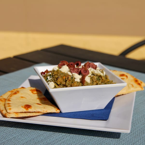 Spiro's Taverna's Greek eggplant dip with feta and olives, served with pita bread.